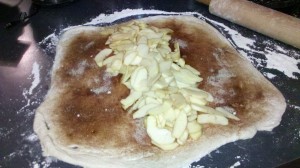 Lining apples down center of bread